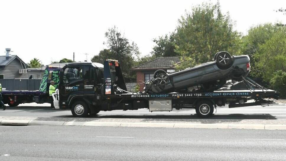 A Holden Commodore was towed after flipping on Napier Street. Picture by Noni Hyett