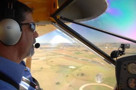 A light plane pilot flies over rural paddocks. Picture supplied