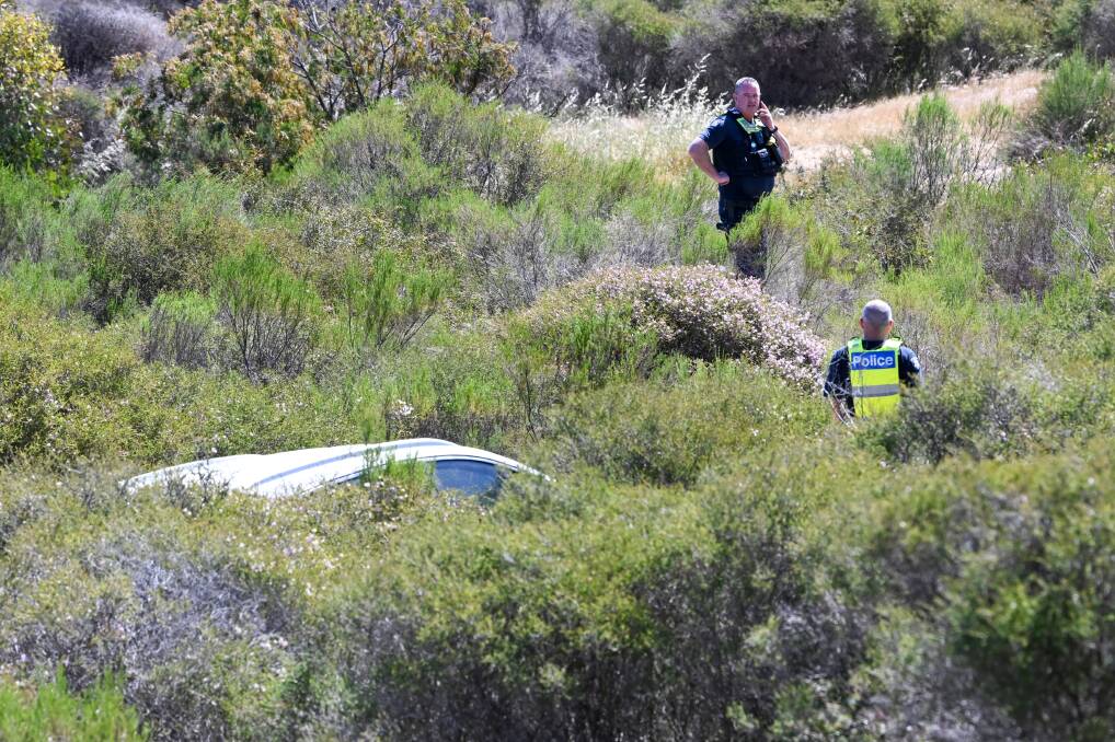 Police inspect a stolen white Kia Sportage dumped at Long Gully on Tuesday. Picture by Darren Howe