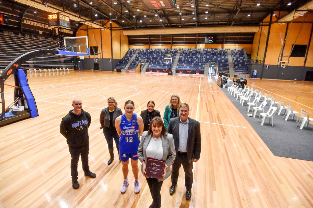 Red Energy Arena's Anita Harrington, holding the award, with Sam Cartwright, Danielle Alford, Braves player Amy Attwel, Nicole McNamarra, Naomi Johnston and Dennis Bice. Picture by Darren Howe