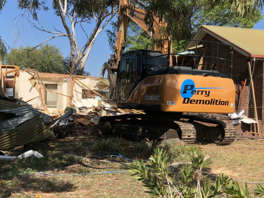 Machinery crushes the 40-year-old brick building, which was largely funded by the community. Picture supplied.