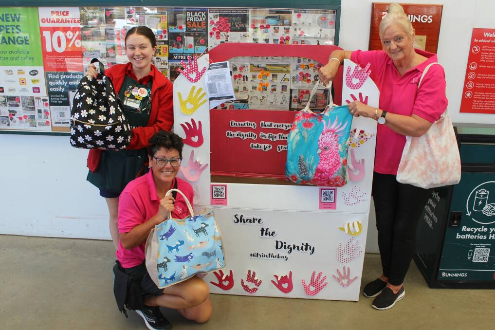 Bunnings worker Tanna Biggs and Share the Dignity volunteers Janet O'Brien and Glenys Nancarrow show off some of the bags already donated at Epsom. Picture by Jenny Denton