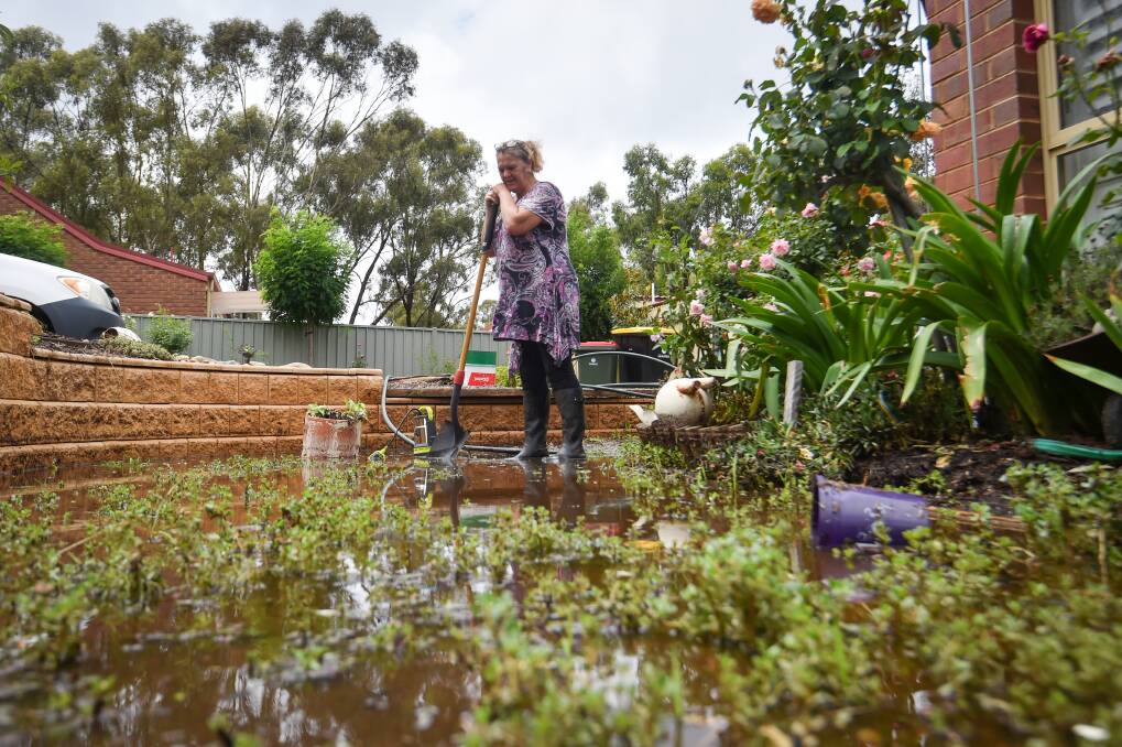 Debbie Dean at the front of her Gungurru Road home, which flooded. Picture by Darren Howe