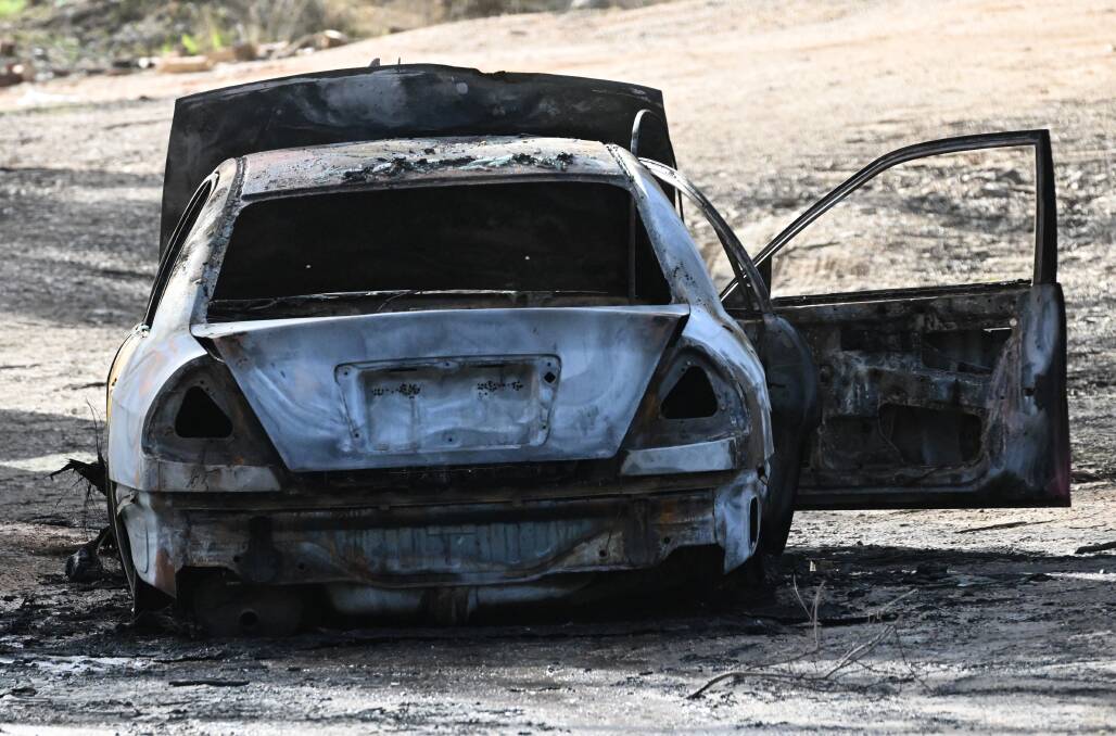 The burnt-out Mitsubishi remained at Burnside Road on Friday. Picture by Darren Howe