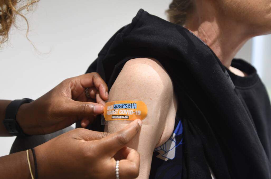 A woman receives a COVID vaccination at Terry White Chemmart in Bendigo. Picture by Noni Hyett
