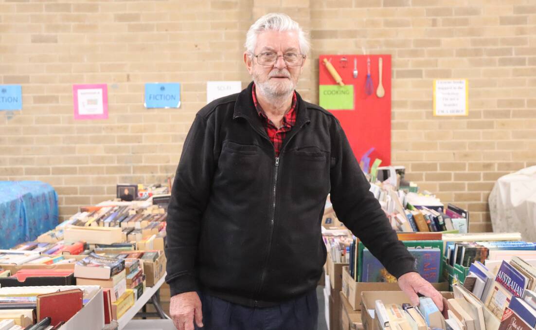 DONATIONS: Volunteer Wayne Morris cleans, sorts and prepares thousands of donated books to go to the store. Picture: LUCY WILLIAMS 