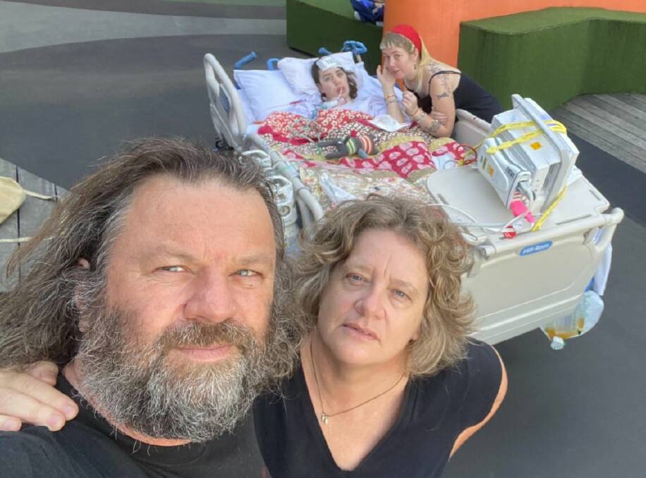 The Lewis family on Anzac Day, when three nursing staff were able to carefully wheel Kate's bed and equipment outside at the Royal Melbourne Hospital. Picture supplied.