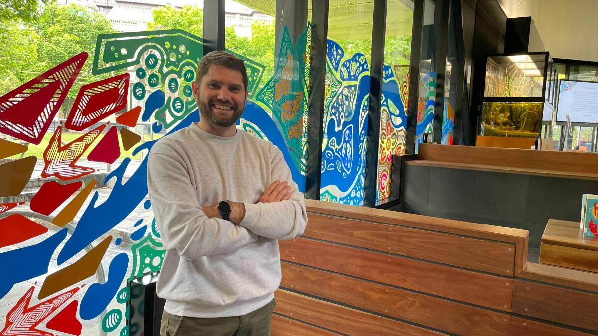 Troy Firebrace with his latest mural of Bendigo Creek at the Bendigo Library. Picture by Jonathon Magrath