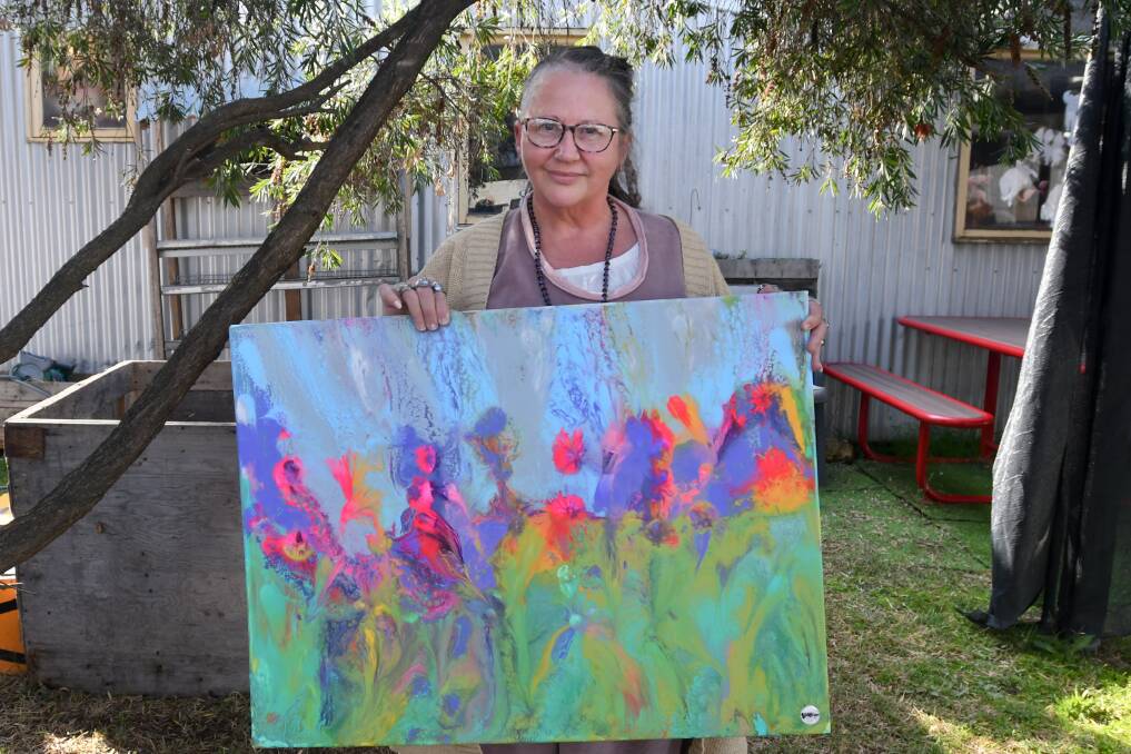 Leisa George with one of her fluid art pieces. Picture by Noni Hyett