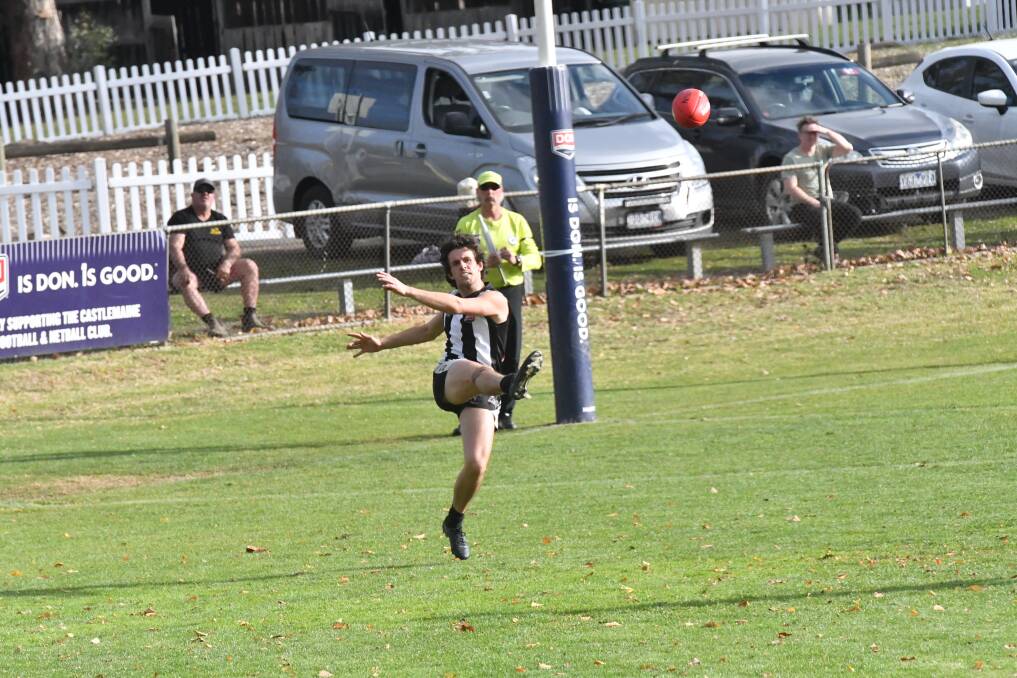 Castlemaine's Darby Semmens boots it out of defensive 50. Picture by Nathan Spicer