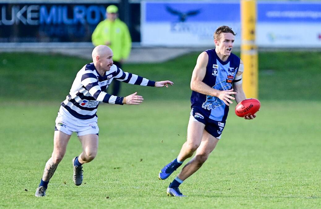 Charlie Langford escapes the clutches of Lachlan Sharp. Picture by Brendan McCarthy 
