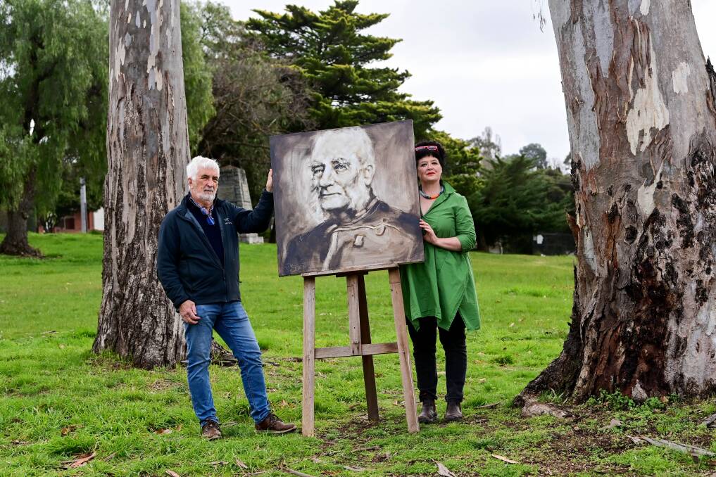 Gold Camp Castlemaine leaders John Lewis and Alice Matthiesson with a painting of Captain Bull at the Camp Reserve site. Artwork by Jennifer Barnett. Picture by Brendan McCarthy 