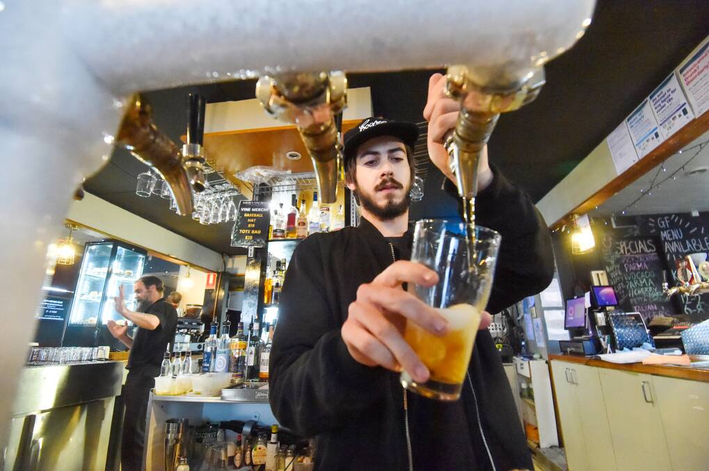 Josh Hamblin pours a beer at the Golden Vine Hotel ahead of a new $80 per keg beer tax. Picture by Darren Howe