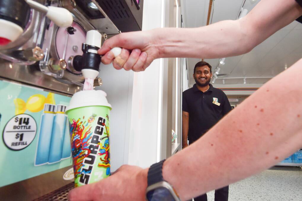 7-Eleven Strathfieldsaye store manager Dinesh Jakkidi watches a perfect Slurpee pour. Picture by Darren Howe