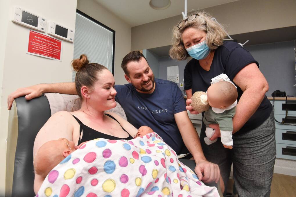 New parents Megan Baird and David Maxey with twins Theodore and Addison learn some tricks from lactation consultant Rachael Findlay. Picture by Darren Howe
