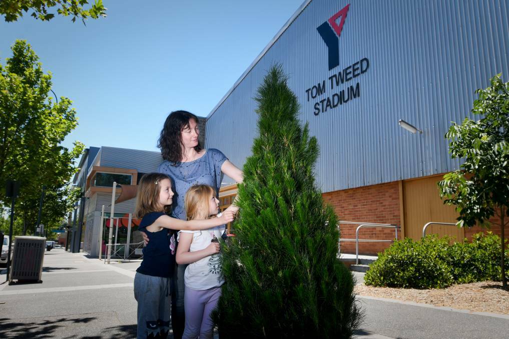 Chloe and Lucy join mum Melissa Abel to pick the perfect tree from the Y Service Club in 2020. Picture by Noni Hyett 
