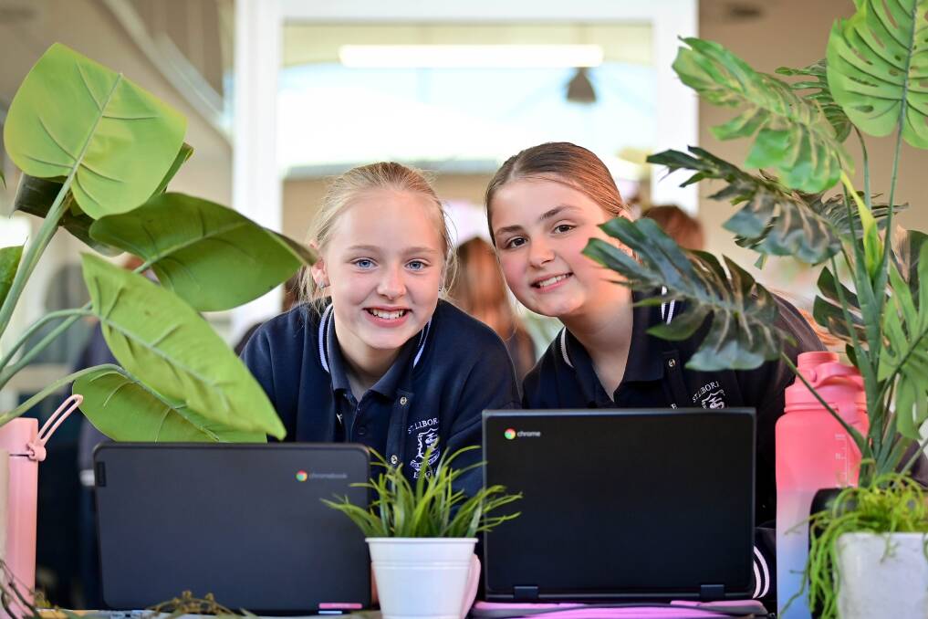 Mia and Evie at work on their science project during expo. Photo by Brendan McCarthy