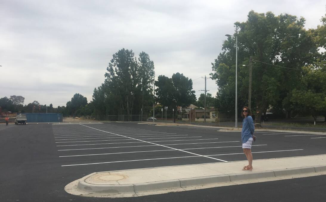 Zoe Carney in the almost-empty car park at Castlemaine Railway Station, which she says is an eyesore for the heritage precinct. Picture: Adam Holmes
