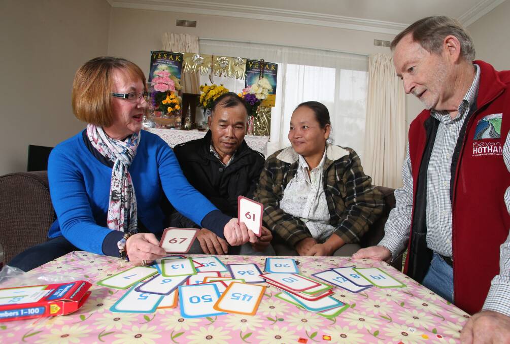 LEARNING TOGETHER: Volunteer tutors Liz McDonnell and Lindsay Jolley work with Poe Thei and Mu Mu on the English words for numbers at the Karen family's home in Long Gully. Picture: GLENN DANIELS