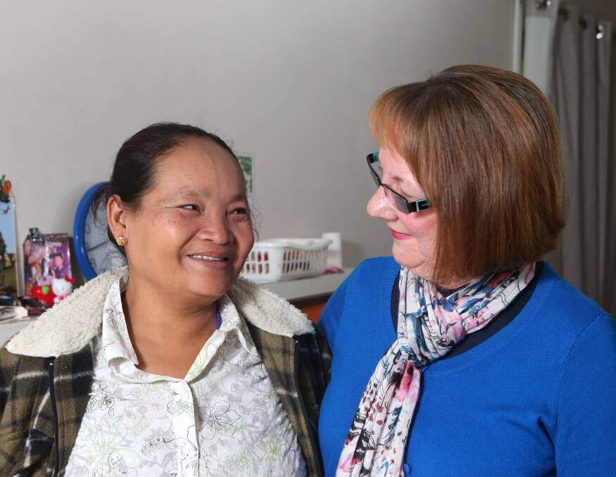 FRIENDSHIPS FORMED: Volunteer tutor Liz McDonnell and Mu Mu at the Karen family's home in Long Gully. Picture: GLENN DANIELS