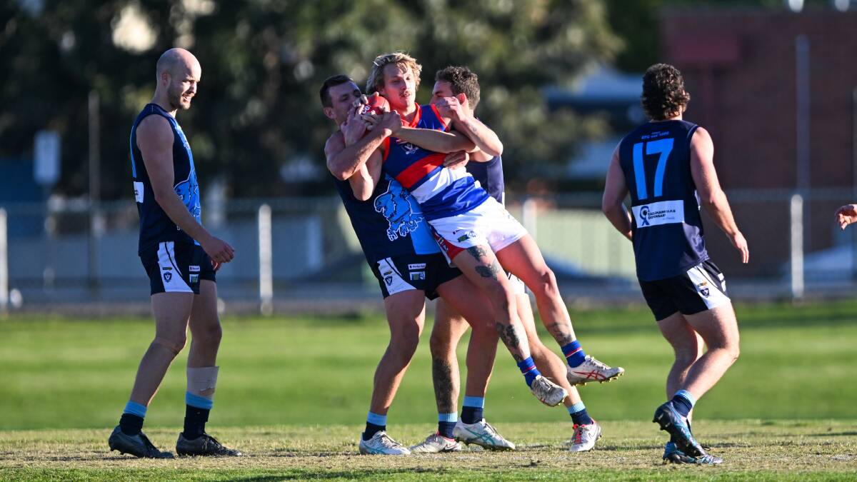 Gisborne midfielder Brad Bernacki is wrapped up in a tackle against Eaglehawk on Saturday. Picture by Enzo Tomasiello