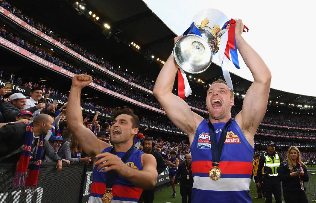 Jake Stringer holds aloft the AFL premiership cup after the Western Bulldogs' 2016 grand final win over Sydney. Picture by Getty Images