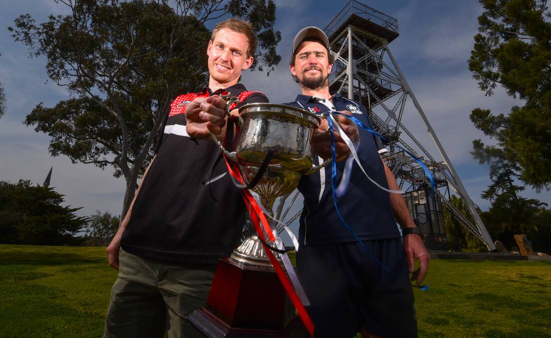 Heathcote captain Codie Price and Mount Pleasant co-coach Adam Baird with the HDFNL premiership cup. Picture by Darren Howe