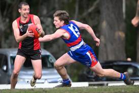 White Hills' captain Rhys Irwin evades North Bendigo's Bailey Cain during Saturday's clash of the top two teams in the Heathcote District league. Picture by Darren Howe