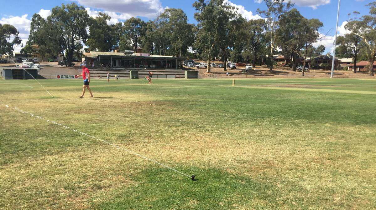 The sprinklers on at Harry Trott Oval during the tea break on Saturday. Picture: HEATH BEHRENS