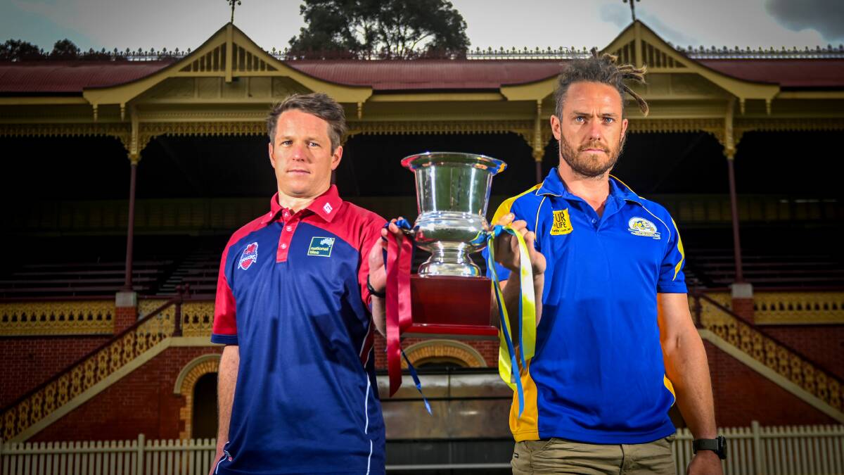 Sandhurst captain Lee Coghlan and Golden Square skipper Jack Geary with the Bendigo Advertiser premiership cup. Picture by Darren Howe