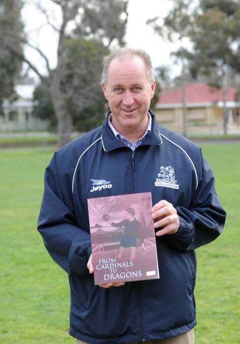 Danny Ellis in 2013 with a copy of the Sandhurst's 150-year celebration book.