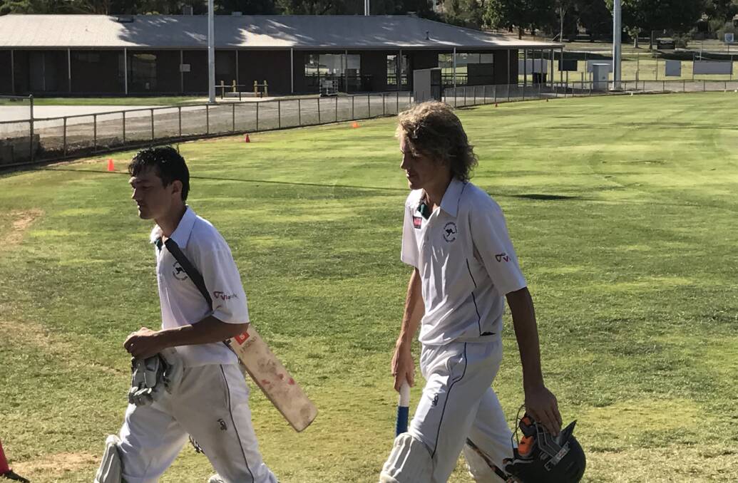 Kangaroo Flat's Chris Barber and Dylan Klemm leave the field after their 10th-wicket partnership heroics against Bendigo on Saturday. Picture: LUKE WEST