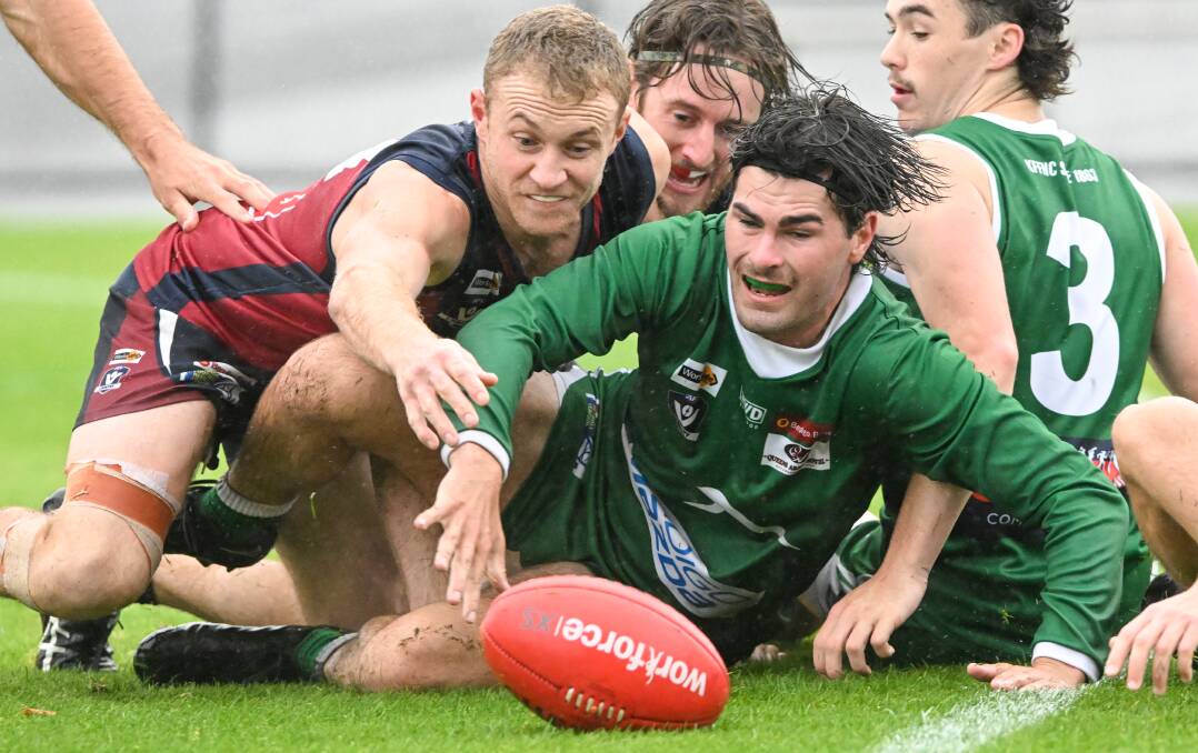 Sandhurst's Zac Pallpratt and Kangaroo Flat's Kyle Symons fight for possession during Saturday's BFNL round one clash at the QEO. The Dragons won by eight points. Picture by Darren Howe