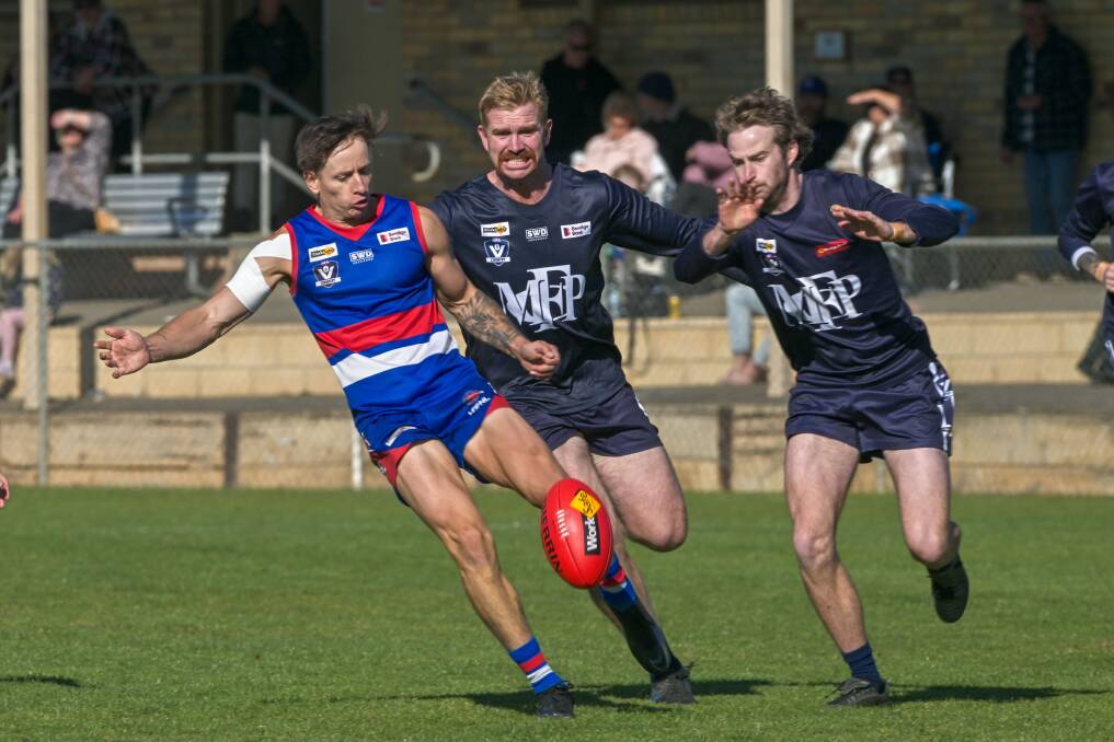 North Bendigo's Nick Waterson gets a kick away under pressure against Mount Pleasant on Saturday. Picture by Enzo Tomasiello
