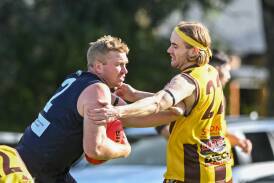 Mount Pleasant's Daniel Frame is pressured by Huntly's Jarrod Spry during Saturday's HDFNL match at Strauch Reserve. Picture by Darren Howe