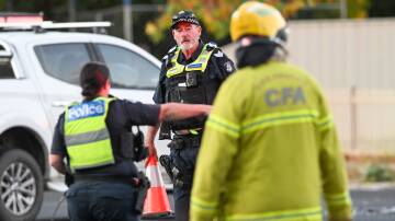 Emergency crew members at the scene of the fatal crash. Picture by Darren Howe.