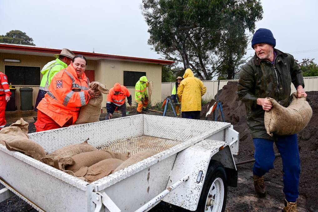 People load sandbags at Marong's CFA headquarters. Picture by Brendan McCarthy.
