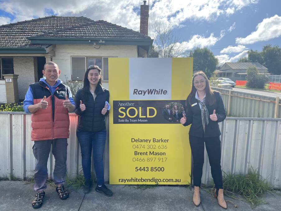Real estate agent Delaney Barker (right) with the buyers of a Long Gully property. Picture supplied