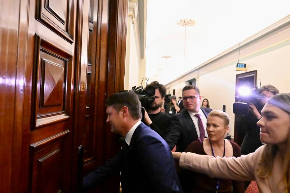 Ben Carroll ignores questions from the media as he re-enters the party room during negotiations over the leadership. Picture by Darren Howe