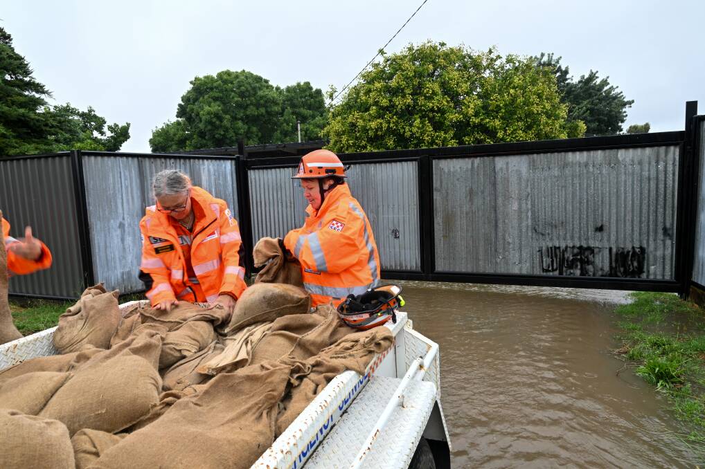 SES crew members help brace a Huntly property for flooding during a downpour in January, 2024. Picture by Enzo Tomasiello