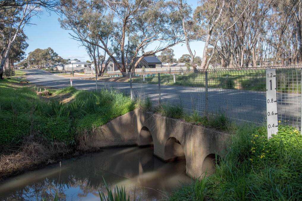 Water pooled across this Carolyn Way bridge during the 2022 floods, which is close to a storm water pipe Meryl Birch says flows down from the Monsants Road area. Picture by Brendan McCarthy