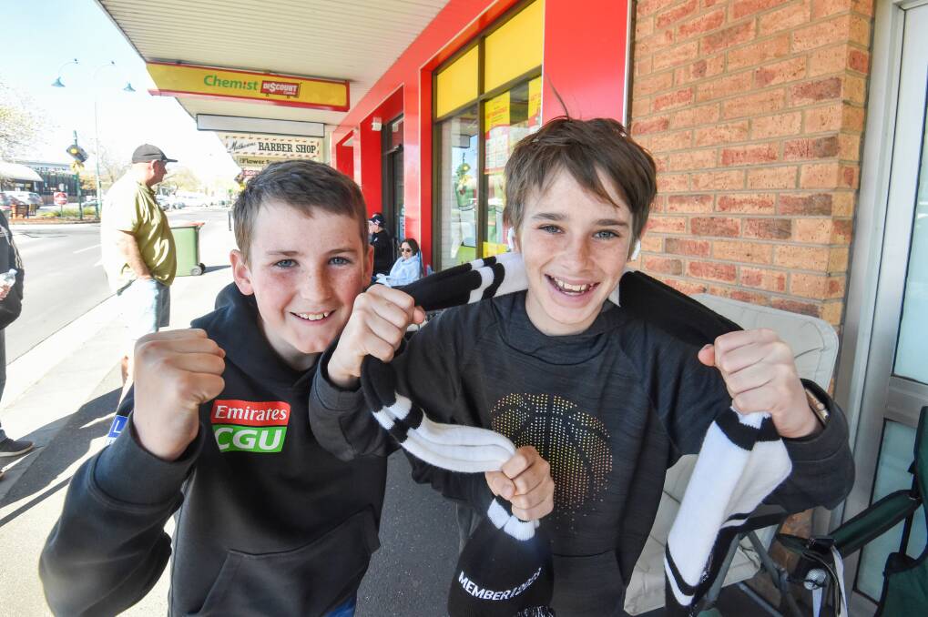 Jed King and Harley Bell wait in line for Grand Final tickets. Picture by Darren Howe.