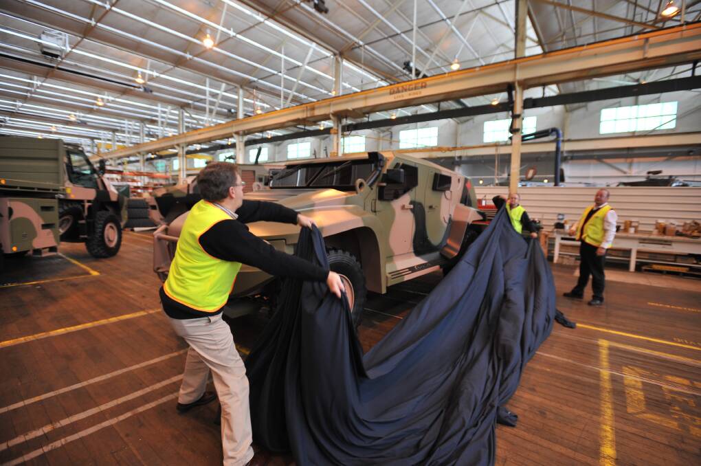 Workers unveiling a Hawkei prototype in Bendigo. Picture by Alex Ellinghausen