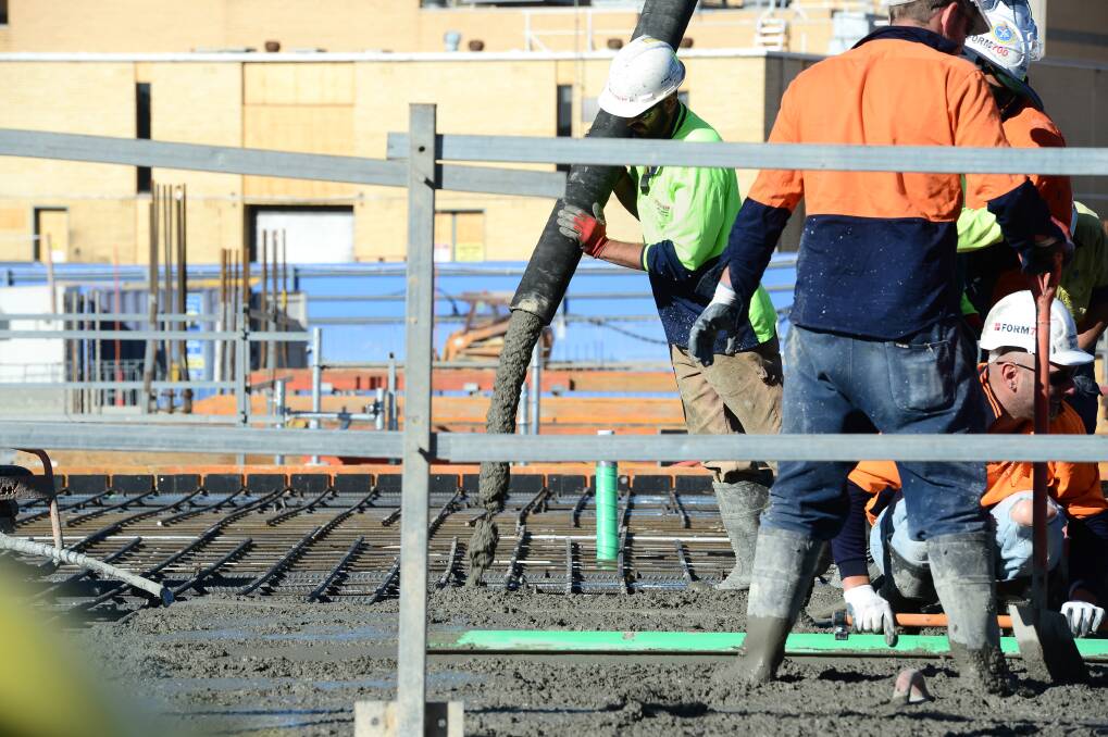 Workers pour a concrete slab in Bendigo. Picture by Jim Aldersey