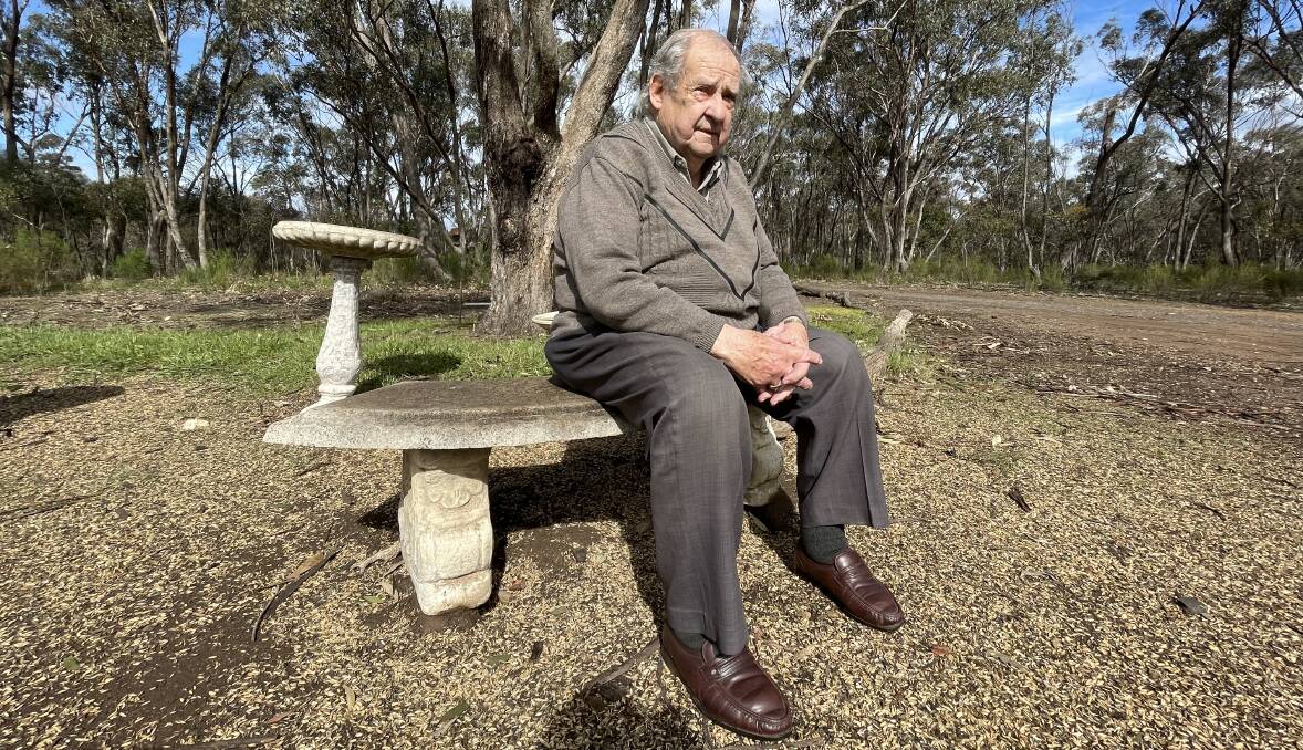 Graham Colling sits on part of his property where he feeds wild native birds seeds. Picture by Tom O'Callaghan
