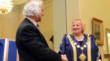 Cr Rodd Fyffe passes the batton to new mayor Cr Lisa Ruffell in 2012. Picture by Jim Aldersey