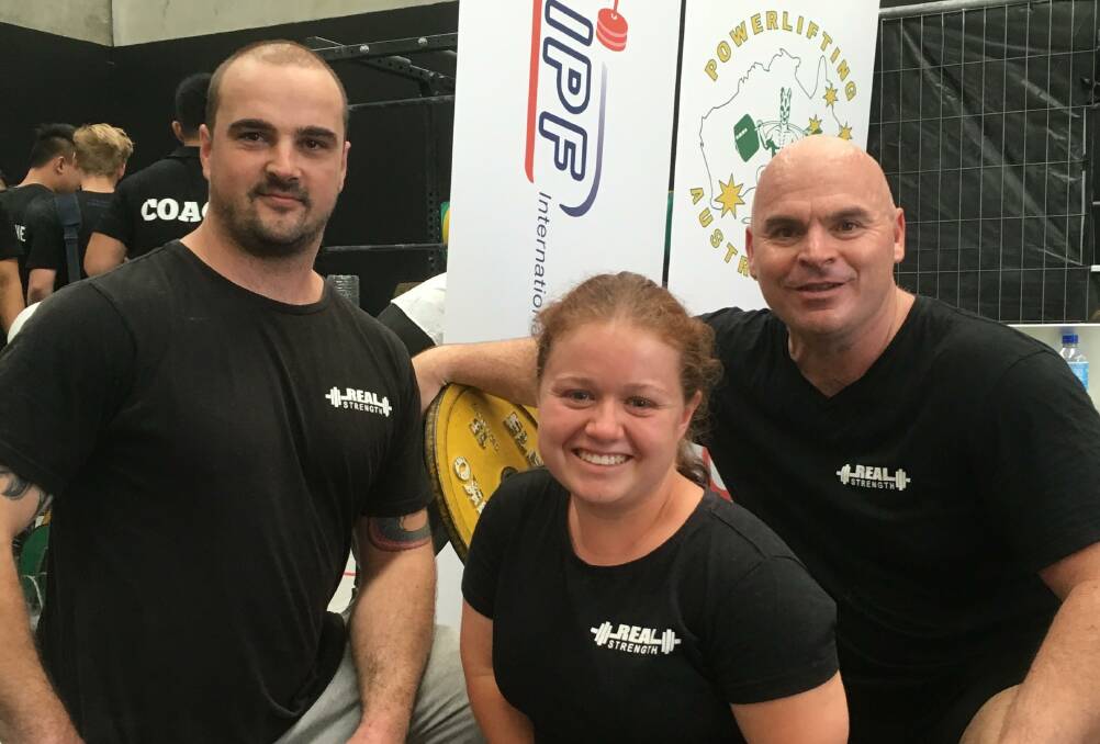 REAL STRENGTH: Daniel Pollard, Ashleigh Hutchins and coach Dean Mawby have produced remarkable results at a powerlifting competition in Melbourne.
