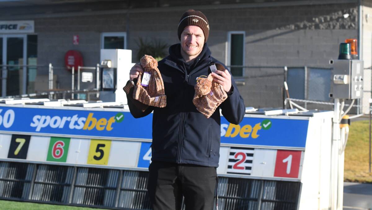 Bendigo Greyhound Racing Association general manager Charlton Hindle with the special Mark Hughes Foundation beanies that are on sale at the club this week as part of its Brain Cancer Race Night this Friday. Picture by Kieran Iles