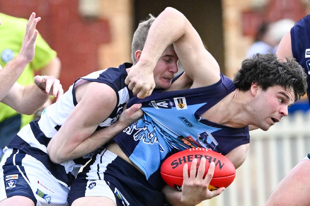 Eaglehawk's Ben Thompson tries to fire out a handball. Picture by Darren Howe