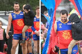 Kain Robins and his children Eden and Jimmy lead Marong onto the ground for his 450th senior game on Saturday. Pictures by Darren Howe